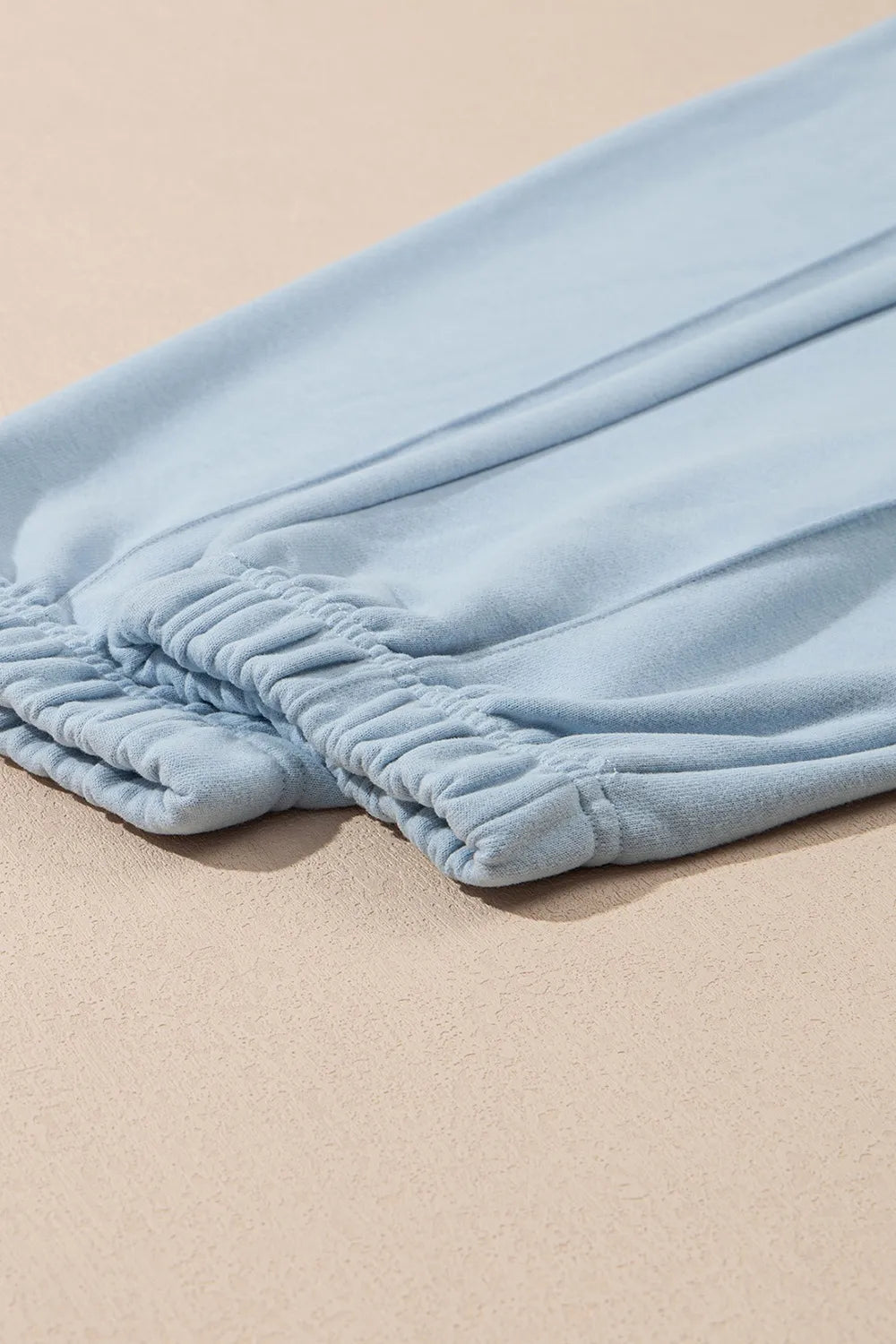 Light blue fabric on a beige surface