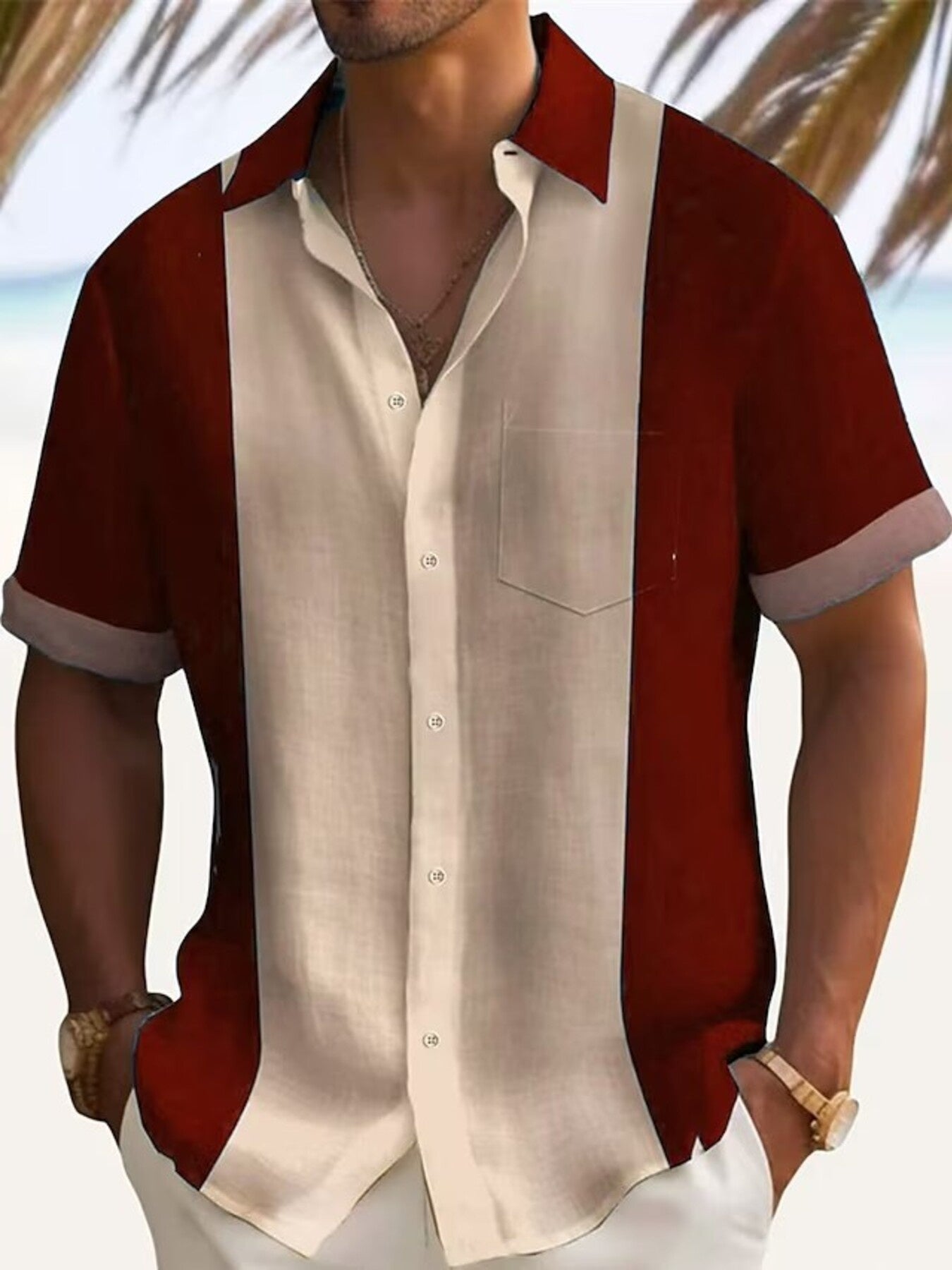 Man wearing a red and beige button-up shirt with a blurred beach background