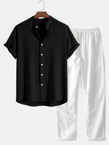 Black cotton short sleeve shirt and white pants on a hanger against a white background
