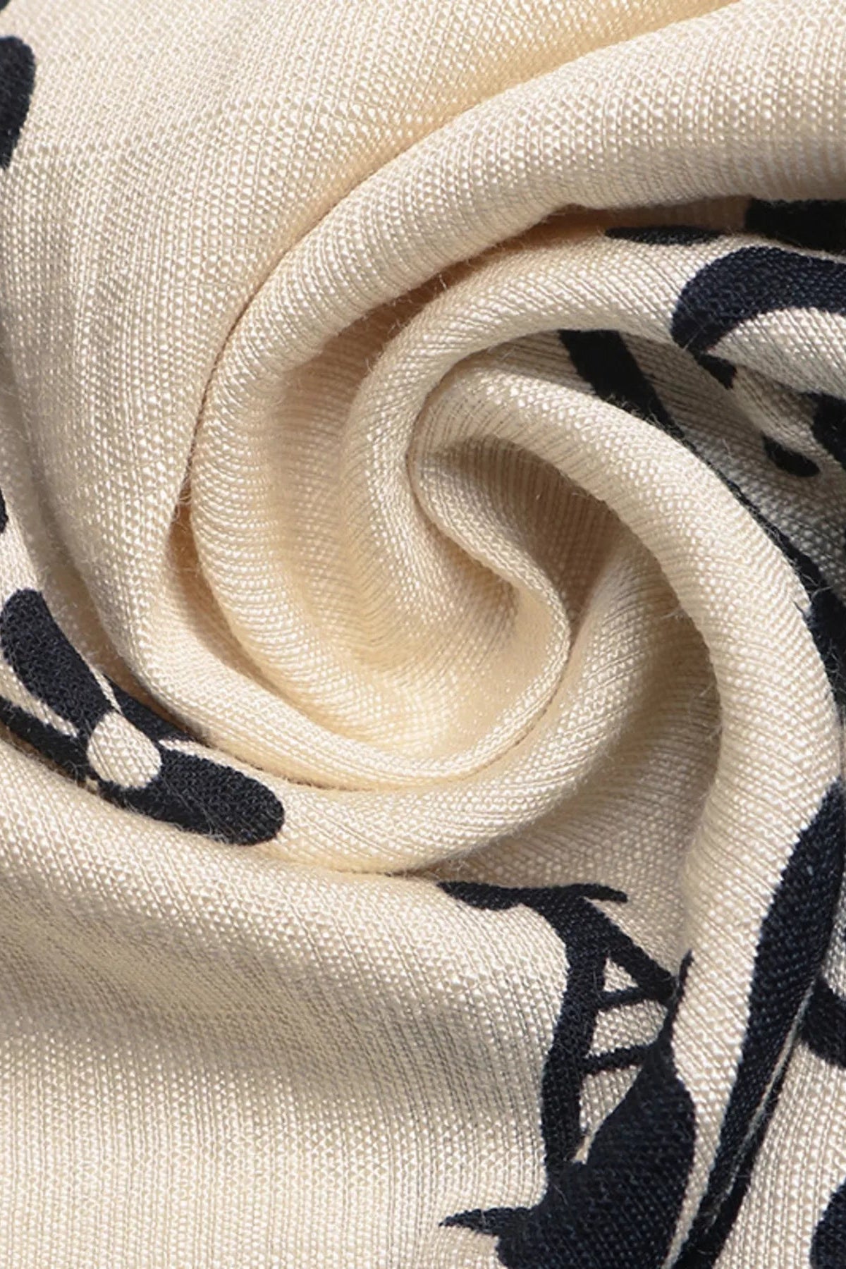 Close-up of cream fabric with black floral patterns