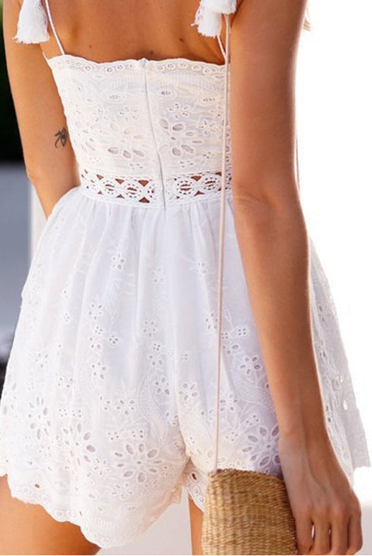 White lace Romper worn by a person with a blurred background