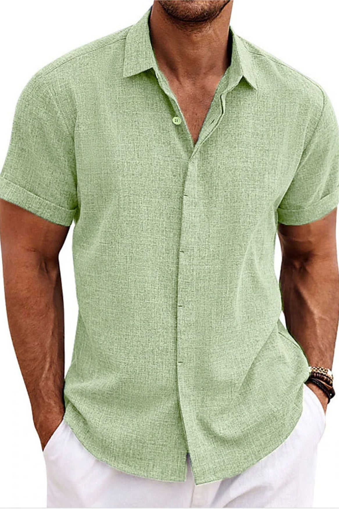 Man wearing a green short-sleeve shirt with a white background