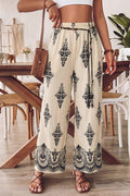 Person wearing floral pants in a dining room setting
