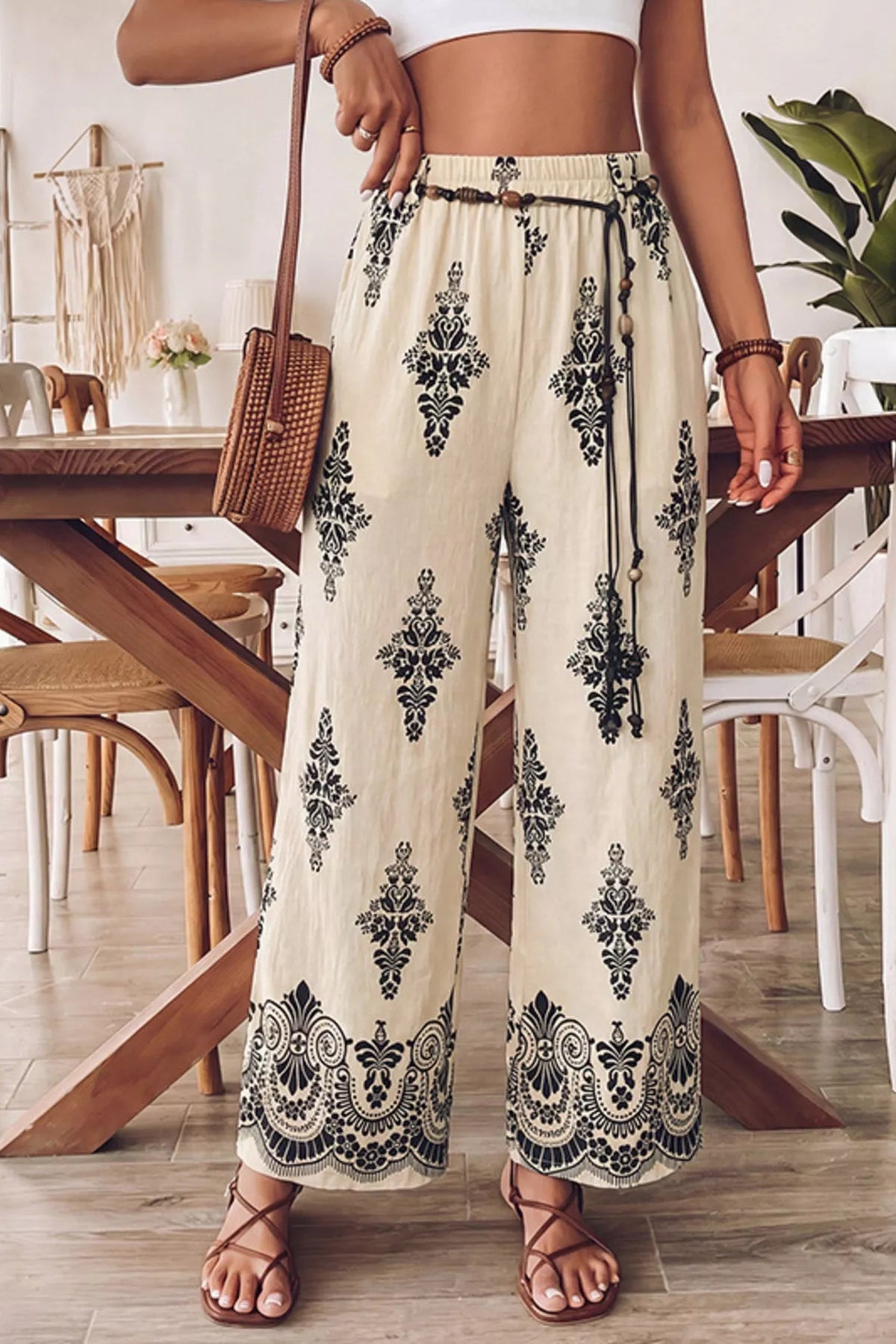 Person wearing floral pants in a dining room setting