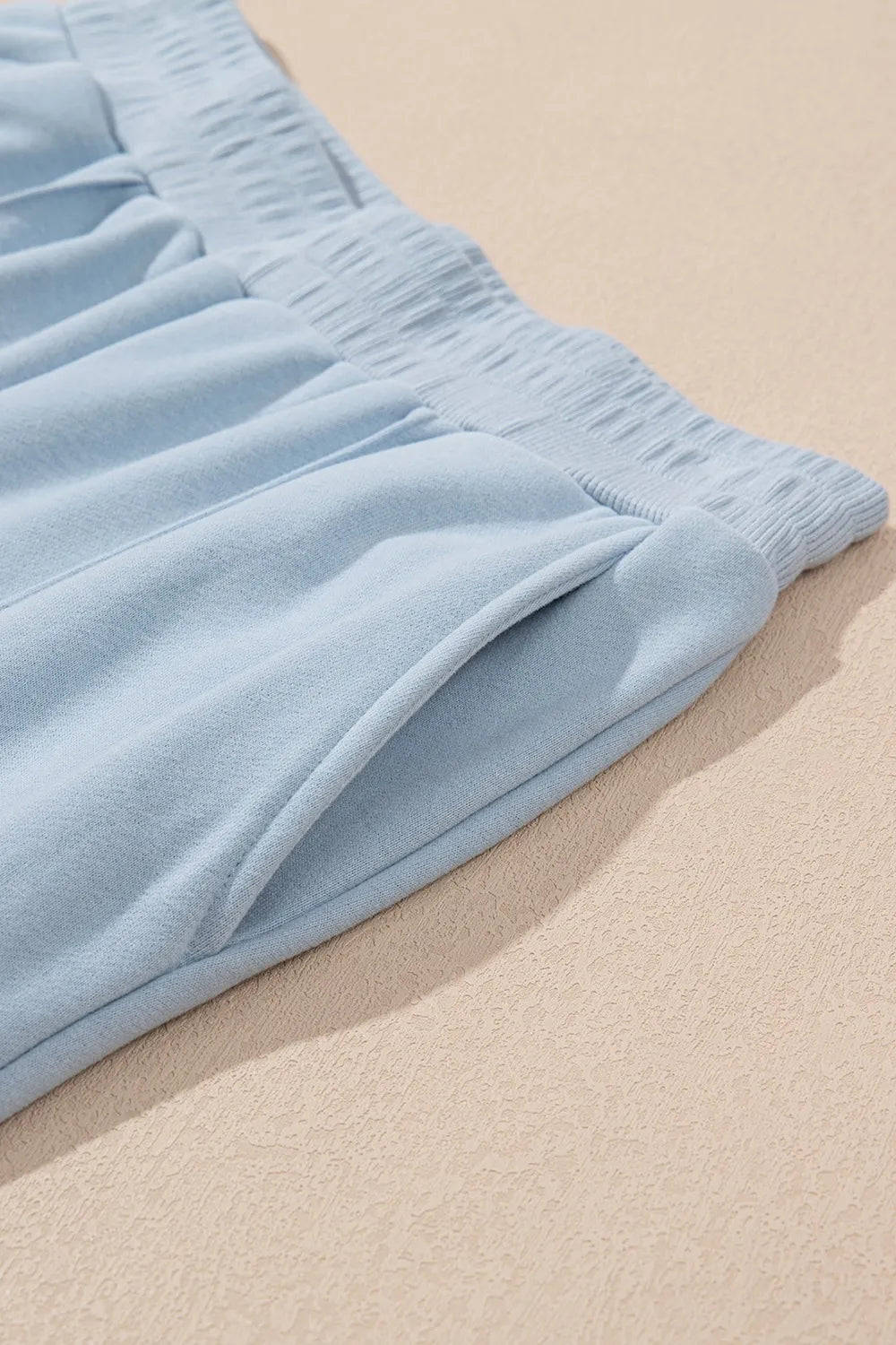 Light blue fabric on a beige surface