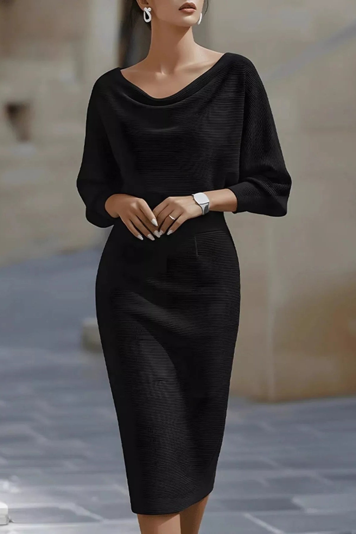Woman wearing a black dress standing on a street.